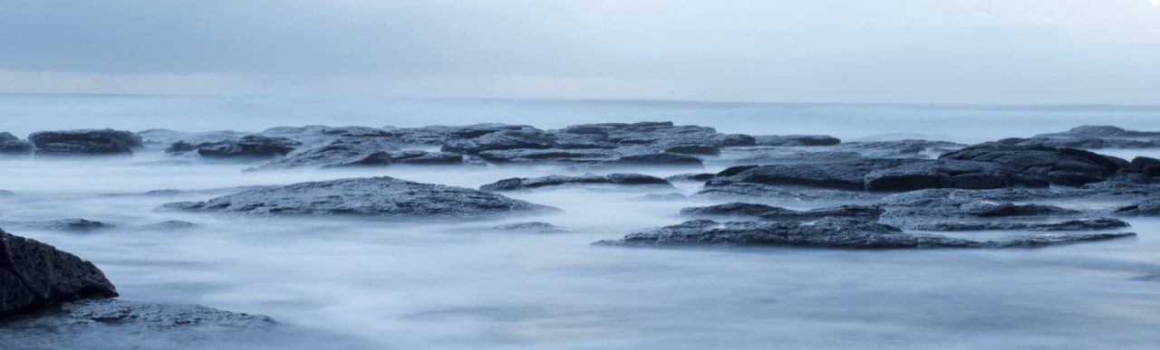 Many flat rocks covered in mist on a cloudy day